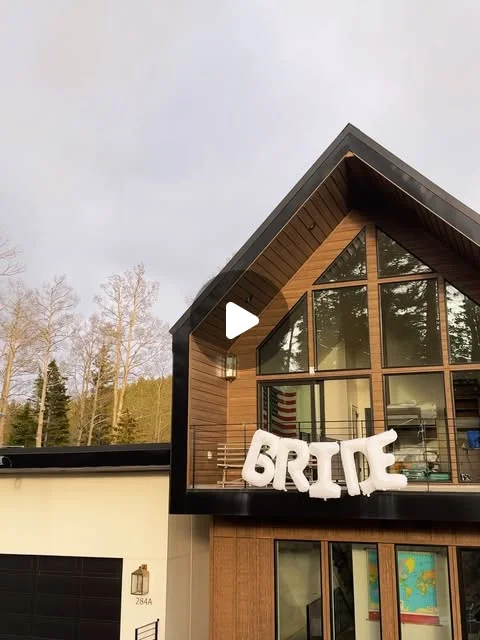 Mountain cabin exterior decorated with BRIDE balloons